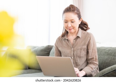 Asian Senior Age Woman Using Laptop