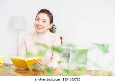 Asian Senior Age Woman Who Reads A Book