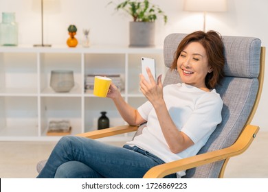 Asian senior age woman who uses smart phone