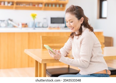 Asian senior age woman who uses smart phone