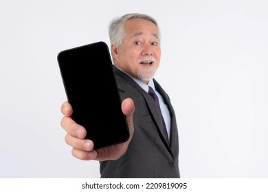 Asian Senior Businessman , Old Man With Suit Feel Happy Pointing Finger To Big Smart Phone With Blank Screen , Black Screen Isolated On White Background - Smart Phone Empty Display Mock Up Image