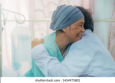 Asian Senior Cancer Patient During Chemo Therapy Feel Happy With Smiling Face And Confident Have Hugging With Doctor