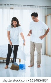 Asian Senior Couple Cleaning Bedroom Floor. Retirement And Healthy Elderly Concept.