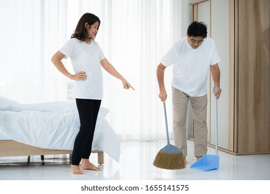 Asian Senior Couple Cleaning Bedroom Floor. Retirement And Healthy Elderly Concept.