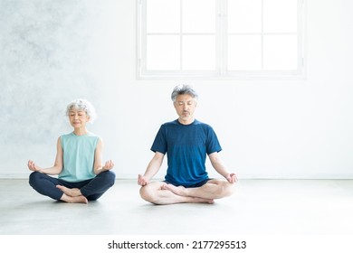 Asian senior couple doing yoga - Powered by Shutterstock