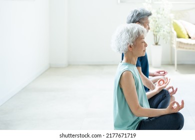 Asian Senior Couple Doing Yoga