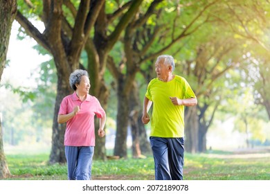 Asian Senior Couple Jogging In The Park