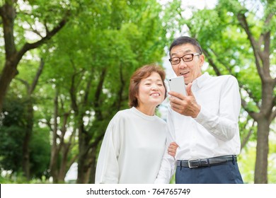 Asian Senior Couple To See A Smart Phone