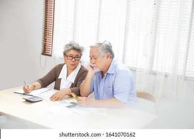 Asian Senior Couple Serious Worried With Calculating Bills To Pay Per Month Or Debt, Retired Elderly Reading Loan Document, Money Problems Concept