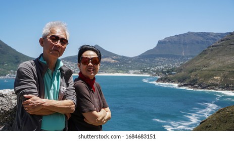 Asian Senior Couple Travel Anniversary Trip In South Africa Beautiful Blue Sea And Sky Beach Coastline