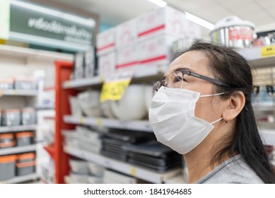 Asian Senior Customer Woman In Face Mask Looking For Product On Aisle At Grocery  Supermarket. New Normal Shopping Lifestyle During Coronavirus Pandemic With Copy Space