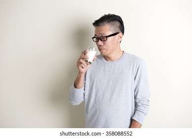 Asian Senior Drinking Milk

