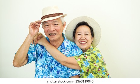 Asian Senior Elder Couple Happy For Holiday Plan Ahead Wearing Hawaii Shirt And Hat