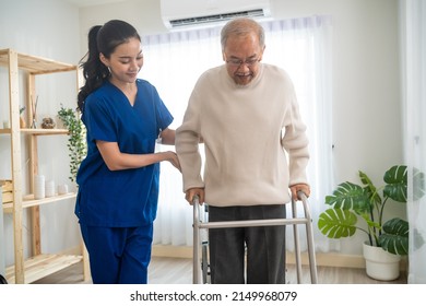Asian senior elderly man patient doing physical therapy with caregiver. Attractive specialist carer women help and support older mature male practice walking slowly with walker at nursing home care. - Shutterstock ID 2149968079