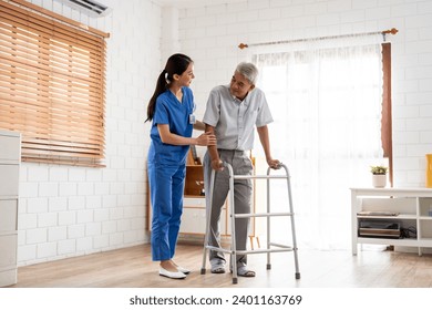 Asian senior elderly man patient doing physical therapy with caregiver. Attractive specialist carer women help and support older mature male practice walking slowly with walker at nursing home care. - Powered by Shutterstock