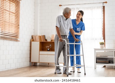 Asian senior elderly man patient doing physical therapy with caregiver. Attractive specialist carer women help and support older mature male practice walking slowly with walker at nursing home care.
 - Powered by Shutterstock