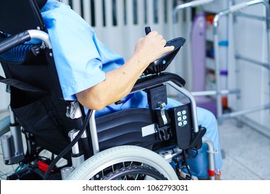 Asian senior or elderly old lady woman patient on electric wheelchair with remote control at nursing hospital ward : healthy strong medical concept 
