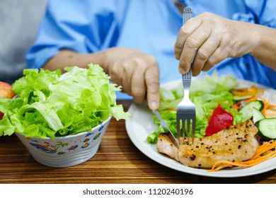 Asian Senior Or Elderly Old Lady Woman Patient Eating Breakfast Healthy Food With Hope And Happy While Sitting And Hungry On Bed In Hospital.
