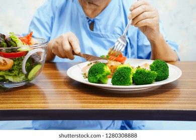 Asian Senior Or Elderly Old Lady Woman Patient Eating Breakfast Healthy Food With Hope And Happy While Sitting And Hungry On Bed In Hospital.
