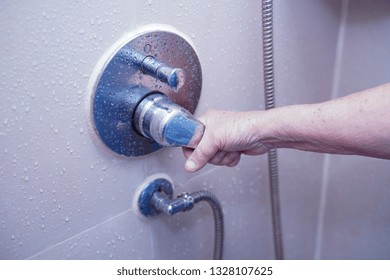 Asian Senior Or Elderly Old Lady Woman Patient Use Toilet Bathroom To Open Shower In Nursing Hospital Ward : Healthy Strong Medical Concept.  
               