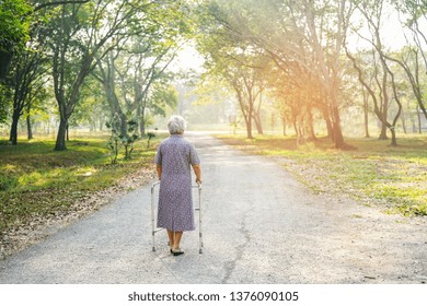 Asian Senior Or Elderly Old Lady Woman Patient Walk With Walker In Park : Healthy Strong Medical Concept.