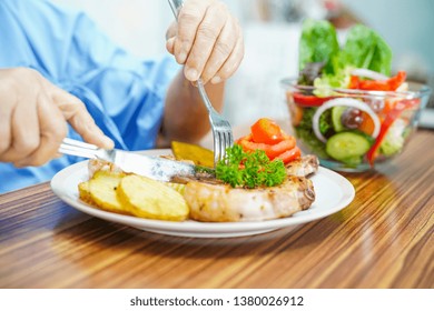 Asian Senior Or Elderly Old Lady Woman Patient Eating Breakfast Healthy Food With Hope And Happy While Sitting And Hungry On Bed In Hospital.
