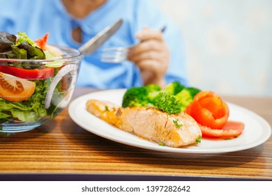 Asian Senior Or Elderly Old Lady Woman Patient Eating Breakfast Healthy Food With Hope And Happy While Sitting And Hungry On Bed In Hospital.
    