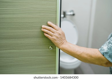 Asian Senior Elderly Old Lady Woman Patient Open Slide Door Of Toilet Bathroom By Hand In Nursing Hospital Ward : Healthy Strong Medical Concept. 