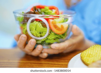 Asian Senior Or Elderly Old Lady Woman Patient Eating Breakfast Healthy Food With Hope And Happy While Sitting And Hungry On Bed In Hospital.
