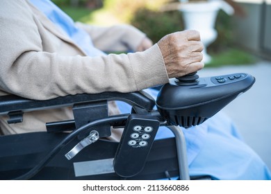 Asian senior or elderly old lady woman patient on electric wheelchair with remote control at nursing hospital ward, healthy strong medical concept