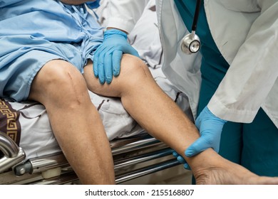 Asian senior or elderly old lady woman patient show her scars surgical total knee joint replacement Suture wound surgery arthroplasty on bed in nursing hospital ward, healthy strong medical concept. - Shutterstock ID 2155168807