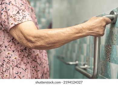 Asian Senior Or Elderly Old Lady Woman Patient Use Toilet Bathroom Handle Security In Nursing Hospital Ward, Healthy Strong Medical Concept.