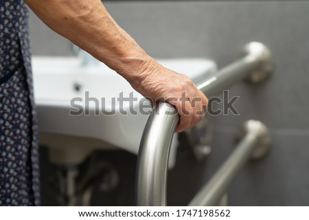 Asian senior or elderly old lady woman patient use toilet bathroom handle security in nursing hospital ward : healthy strong medical concept.