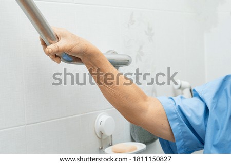Asian senior or elderly old lady woman patient use toilet bathroom handle security in nursing hospital ward, healthy strong medical concept.