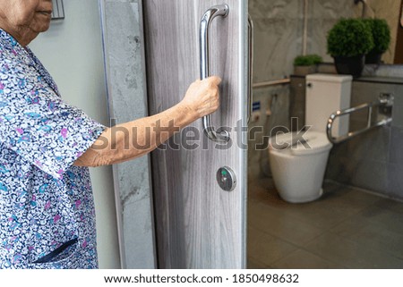 Similar – Caregiver looking through the window with elderly patient in wheelchair