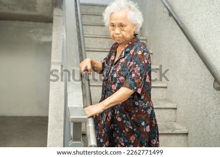 Asian senior or elderly old lady woman patient use slope walkway handle security with help support assistant, healthy strong medical concept.