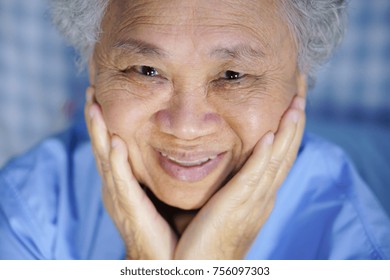 Asian Senior Or Elderly Old Woman Patient Touching Face And Smile In Bed At Hospital.