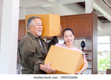 Asian Senior Father And Young Daughter Carrying Boxes Into New Home, Happiness Family On Moving Day Concepts