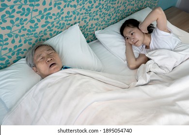 Asian Senior Grandmother Snoring Loudly,open Mouth,feeling Tired Exhausted,unhappy Child Granddaughter Covering Ears With Both Hands,annoyed By The Snoring Of Old Elderly Woman,danger Of Sleep Apnea