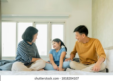 asian Senior grandparents couple laying with grandchildren preety female child on bed in bedroom,happy family play together in the bed - Powered by Shutterstock