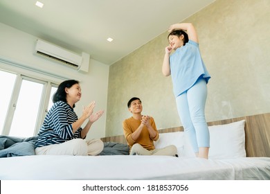 asian Senior grandparents couple laying with grandchildren preety female child on bed in bedroom,happy family play together in the bed - Powered by Shutterstock