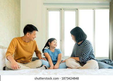 asian Senior grandparents couple laying with grandchildren pretty female child on bed in bedroom,happy family play together in the bed - Powered by Shutterstock