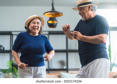 asian senior happiness couple home isolation concept,asian old retired adult couple dancing together at living room with cheerful and joyful moment ,Lovely senior couple dancing at home - Powered by Shutterstock