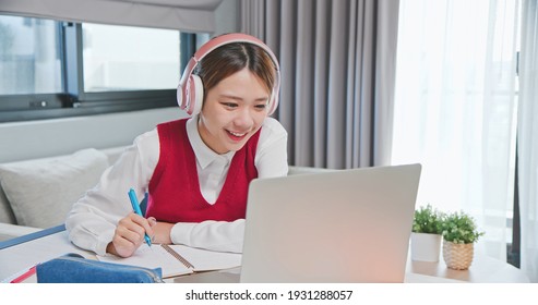 Asian Senior High School Female Student Is Learning And Looking Online Course Through Laptop With  At Home