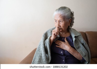 Asian senior ill female have a cough and sore throat. Causes of cough include common cold, flu, respiratory tract infection, pneumonia, bronchitis, allergy or asthma. Elderly health care concept.