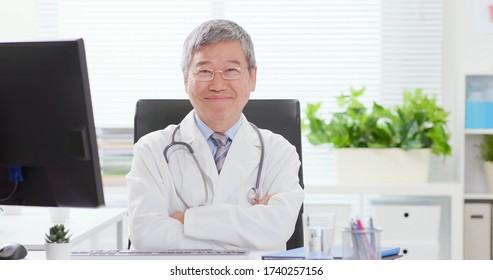 Asian Senior Male Doctor Smile To You In The Clinic