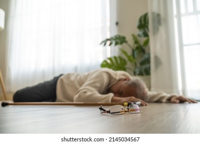 Asian senior male falling on the ground while walk with walker at home. Elderly older mature grandfather having an accident after doing physical therapy alone after retirement in living room in house. - Shutterstock ID 2145034567