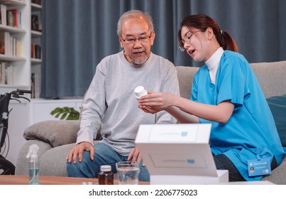 Asian Senior Male Patient Consult Prescription Drug With Physician Nurse At Nursing Home. Caregiver Therapist Pharmacist Woman Hold Medicine Pills Bottle, Medicine Dosage At House In Living Room.