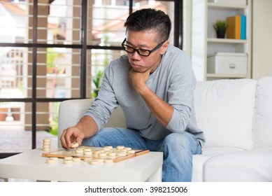 Asian Senior Male Playing Chinese Chess