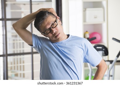 Asian Senior Male Streching At The Gym